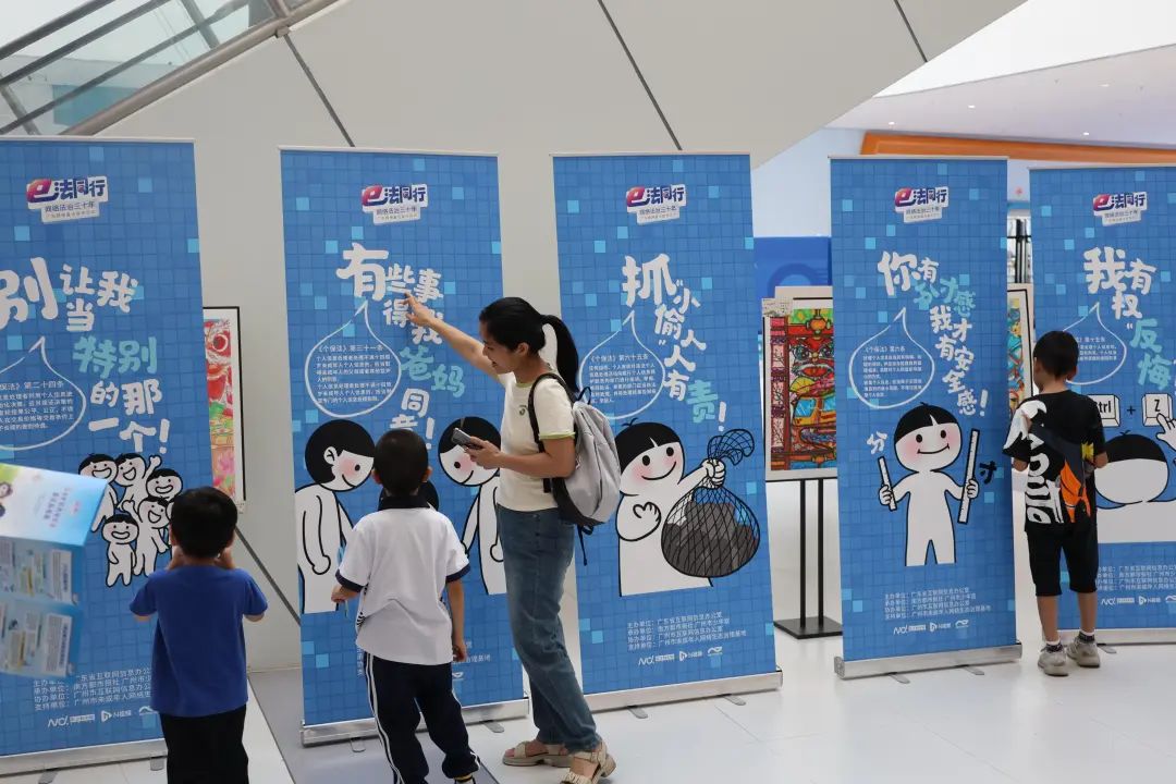 10月19日，在廣州市第三少年宮，家長和小朋友們觀看《個人信息保護法》創(chuàng)意普法展板。
